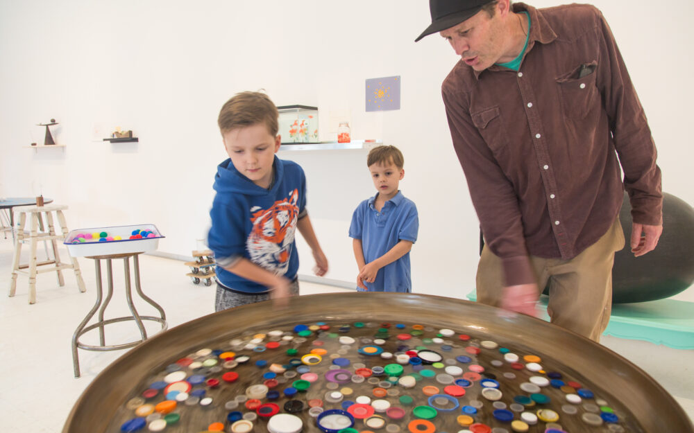 Young visitors engage with a work of art on view