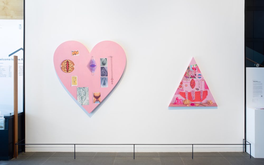 Two large pink canvas works on a white wall
