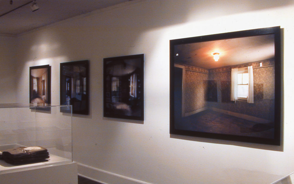 Vintage photographs framed side by side in a gallery.