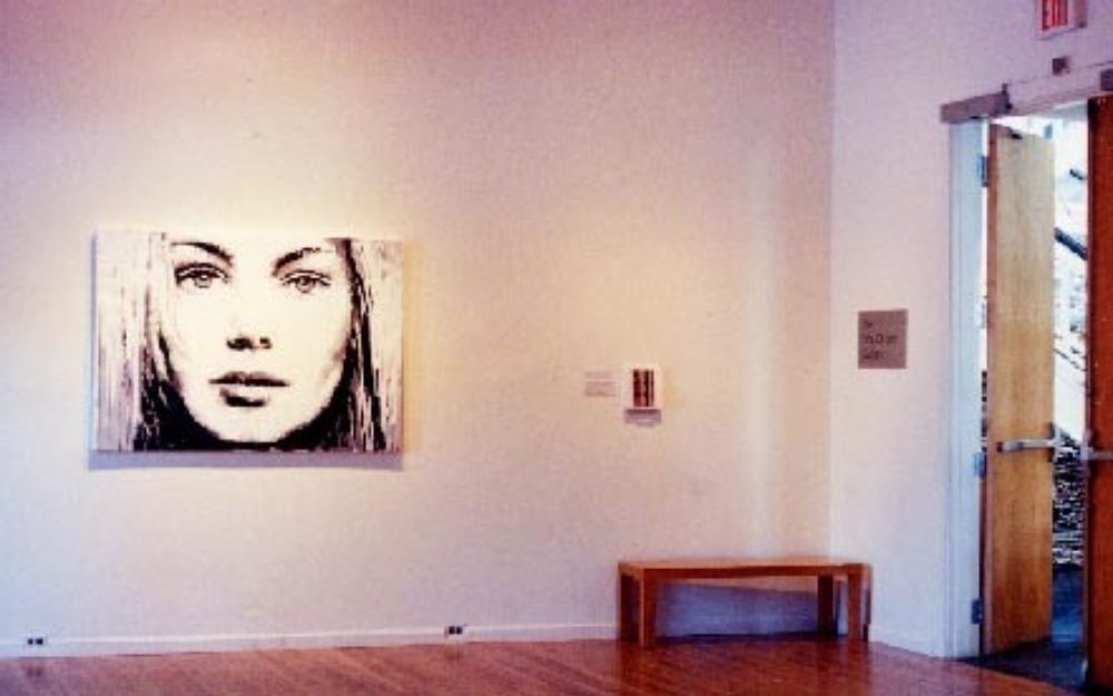 Portrait image on white gallery wall