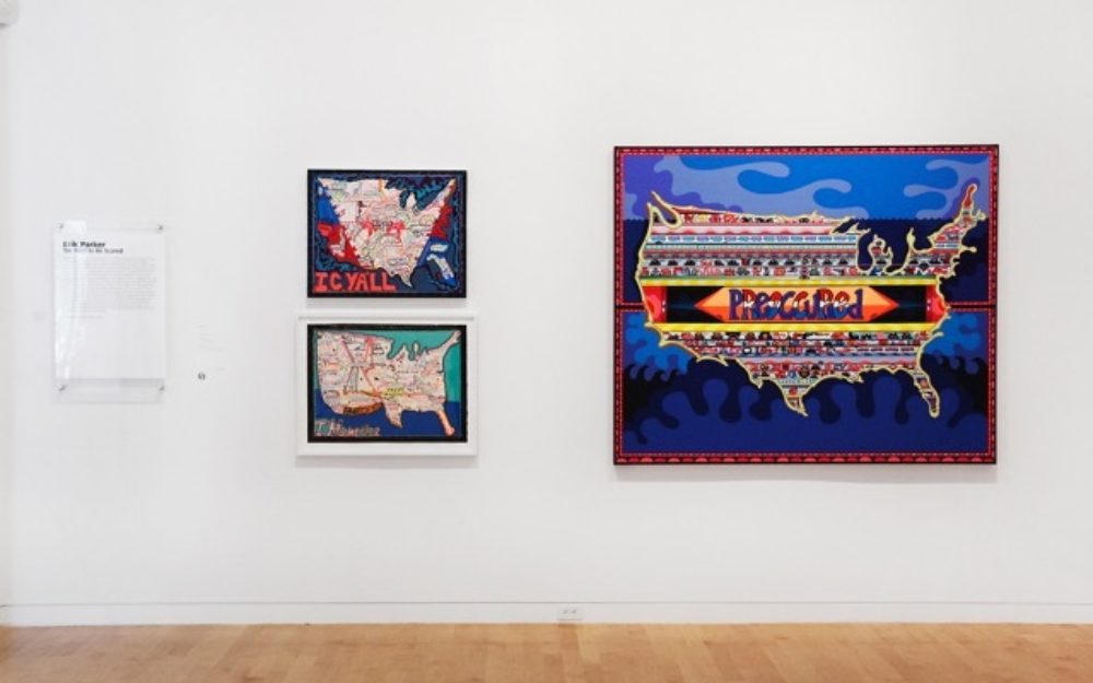Three of Erik Parker's lyrical maps of the United States mounted on the gallery wall