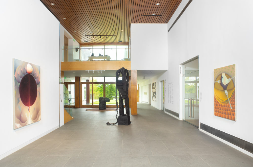 The Museum's lobby with two freestanding sculptures and works hung on the walls.