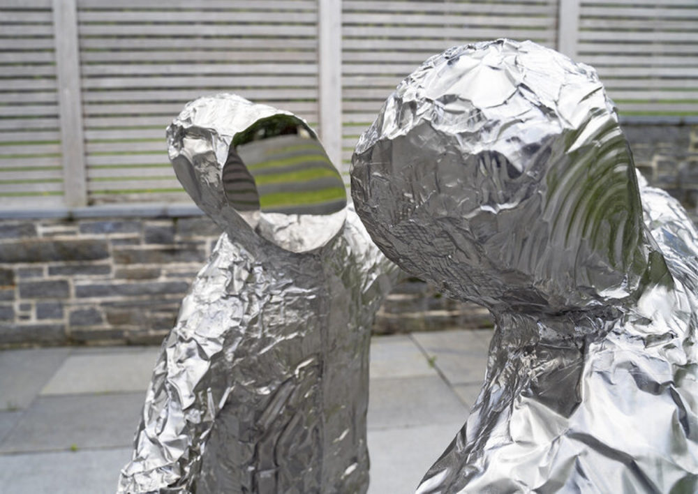 Close up of two figures with mirrored faces