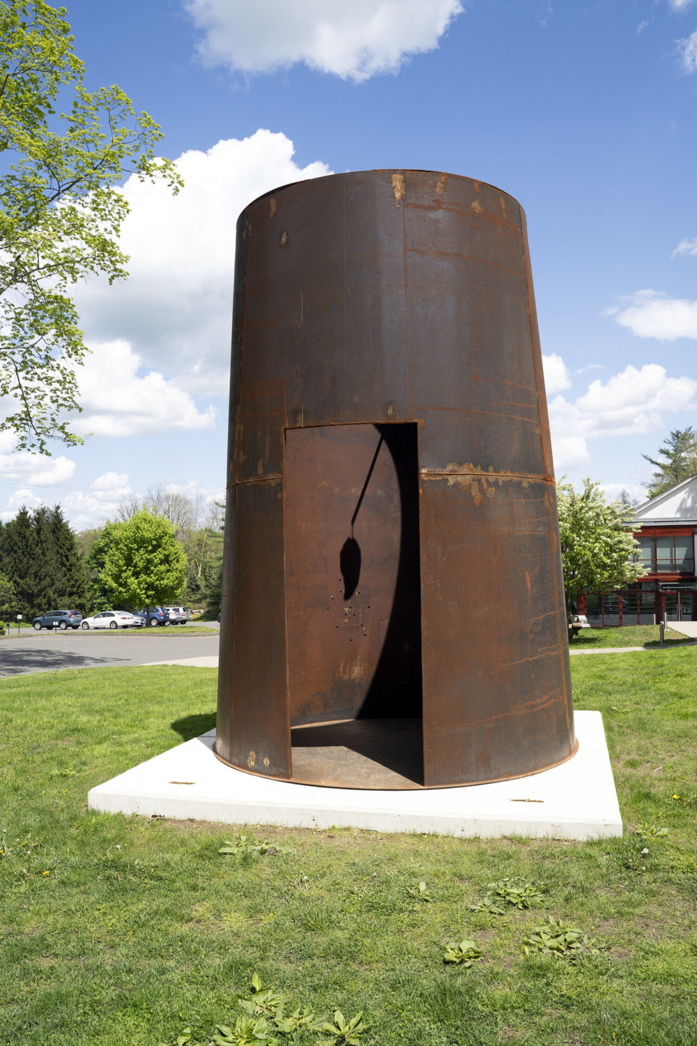 Steel chamber sculpture sits on green lawn
