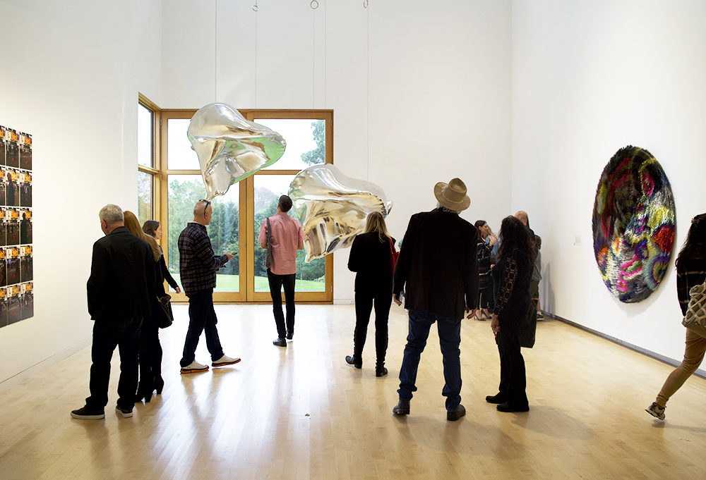 Visitors in a gallery at The Aldrich Contemporary Art Museum observing works of art on view