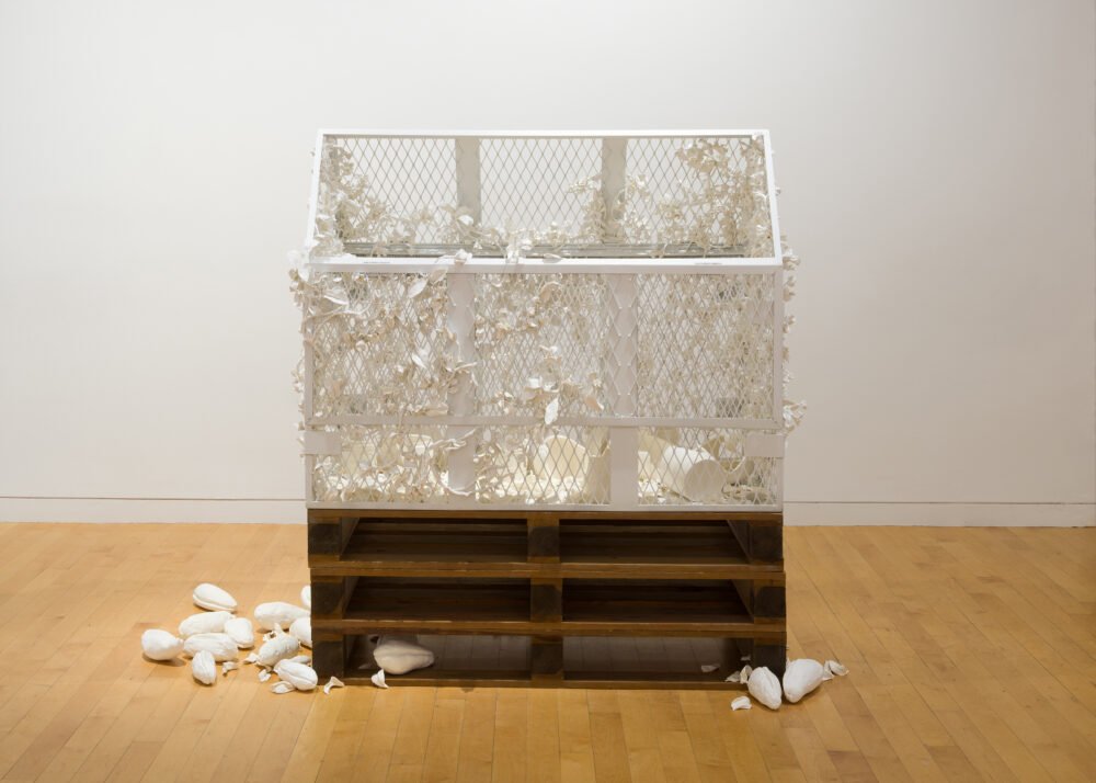 a sculpture of a cage-like box which is constructed of metal and painted white