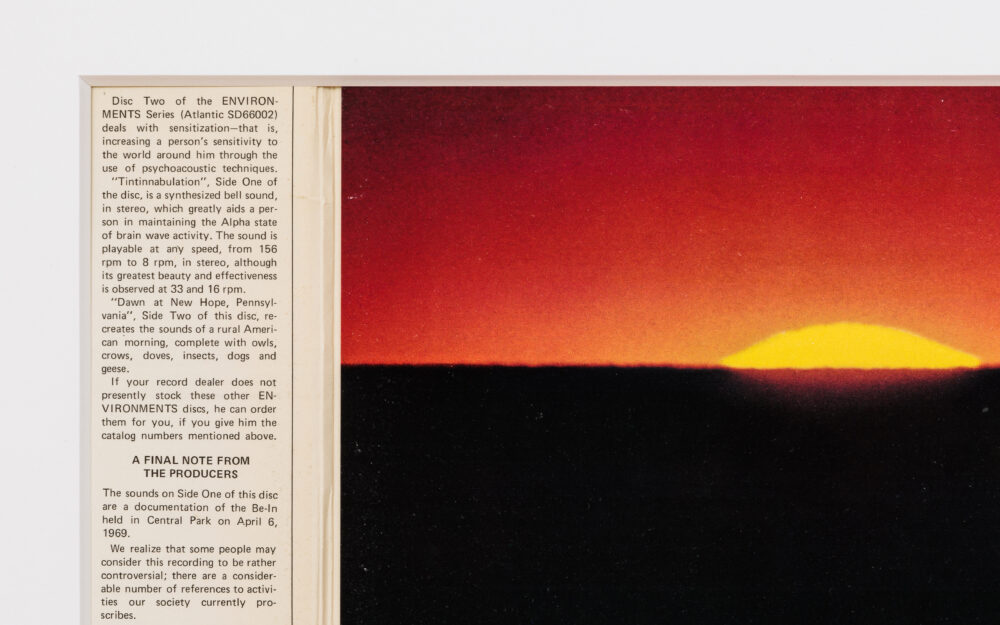 Detail of record cover with a column of text to the left and an image of a sunset to the right.