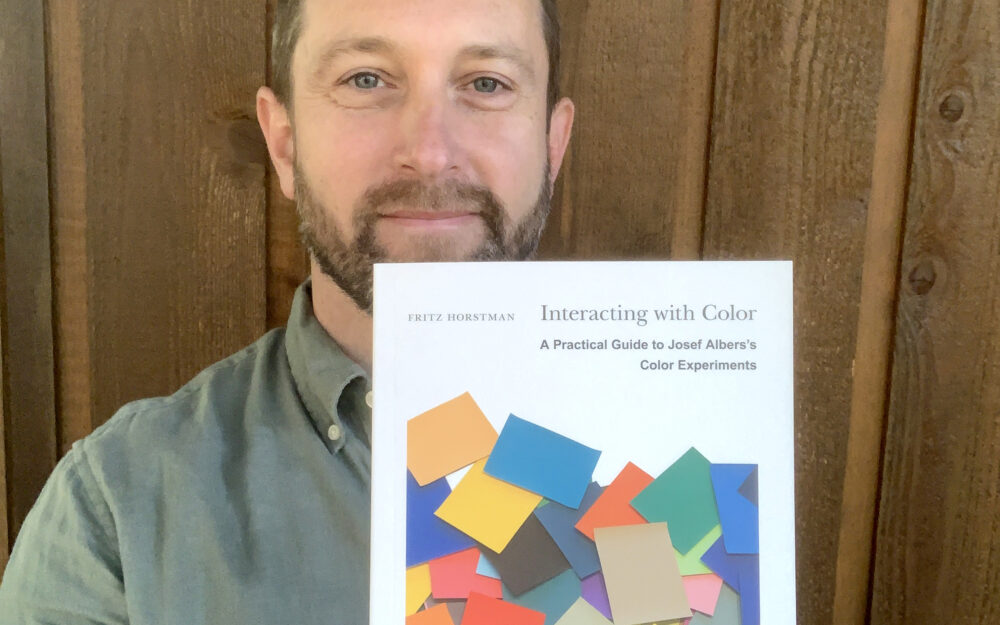 Fritz Horstman holding a copy of his book Interacting with Color