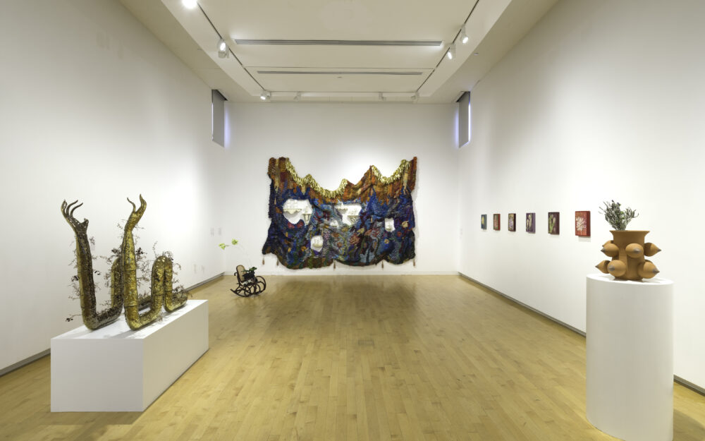 Installation view displaying multiple sculptures in an art gallery.