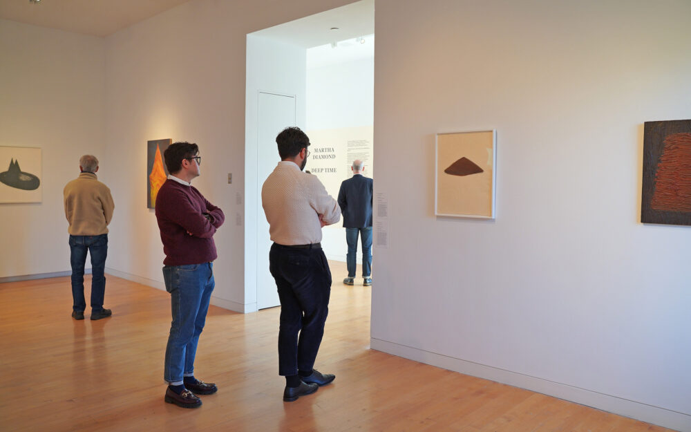 A group of people on a tour of an art museum.