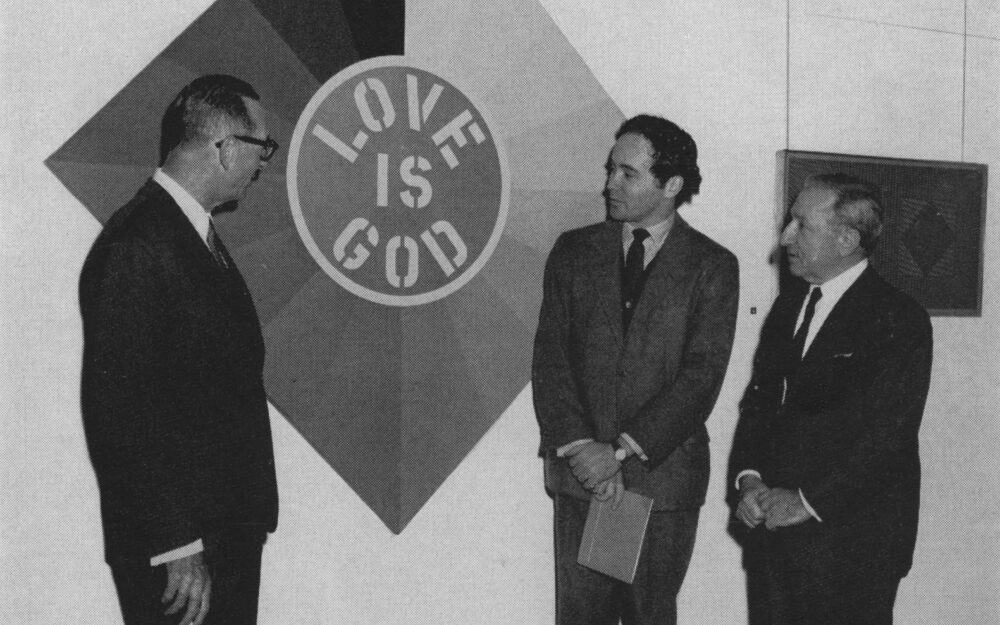 Larry Aldrich Robert Indiana and Jospeh Hirshhorn standing in front of Love Is God in the Old Hundred gallery