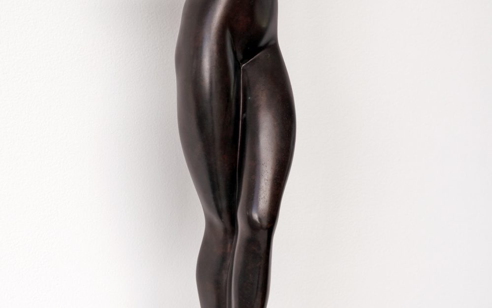 Bronze modernist sculpture of a woman with folded arms