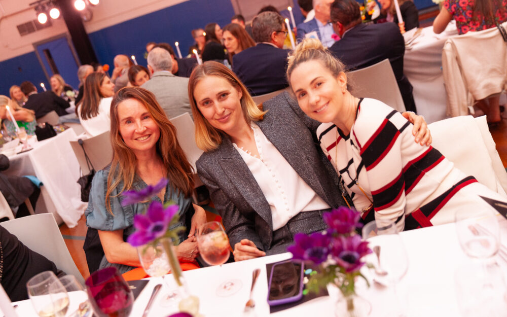 three women at a gala dinner