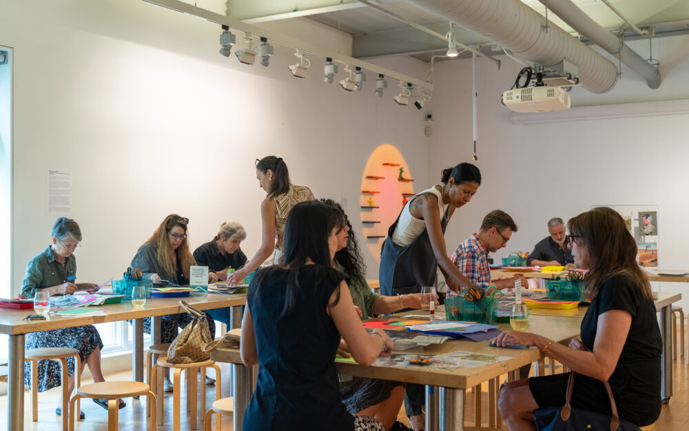 a group of people collaging in an art studio