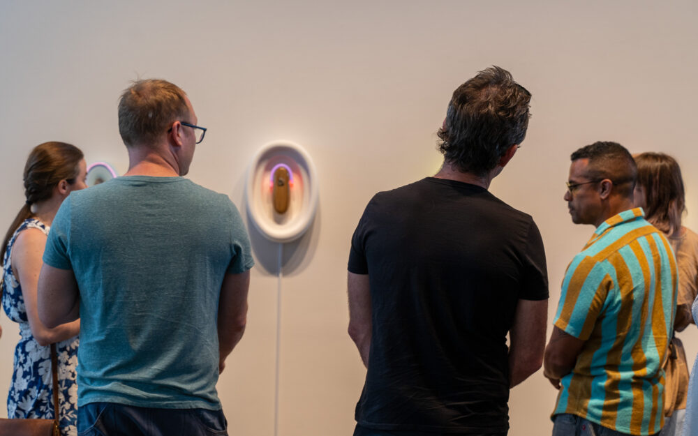 people looking at a sculpture