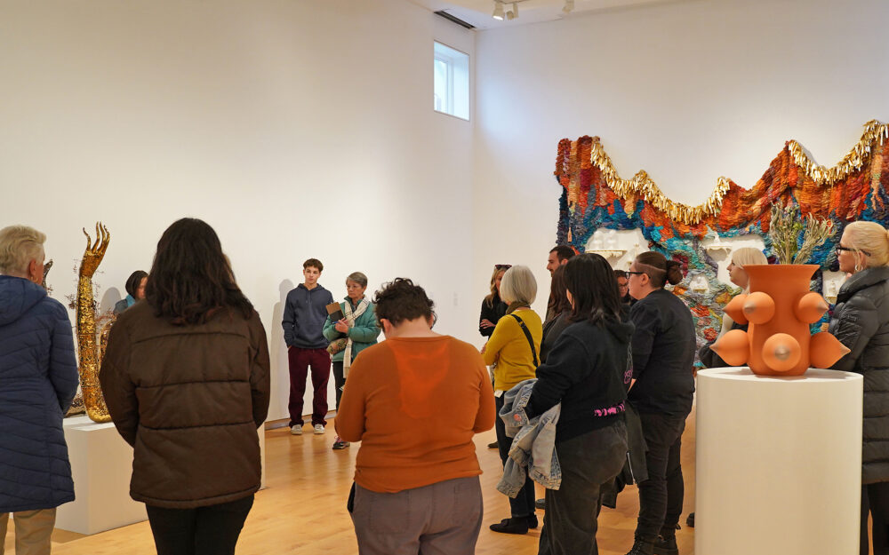 A group of people on a tour of an art museum.