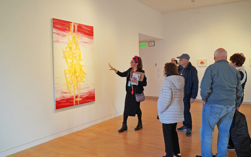 People taking a group tour at an art gallery.