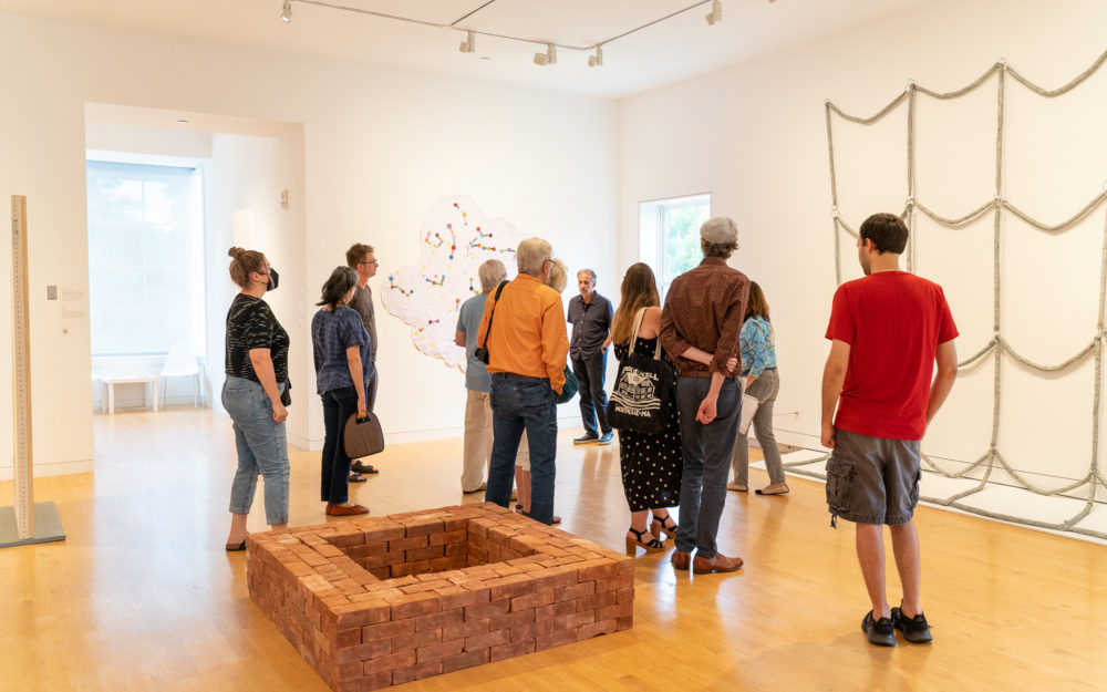 A group of people on a tour of an art museum.