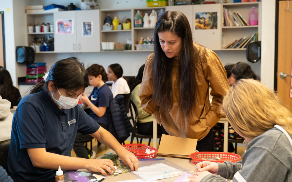 Artist Amanda Martínez overseeing students while they create sculptural relief inspired by Martínez’s work.