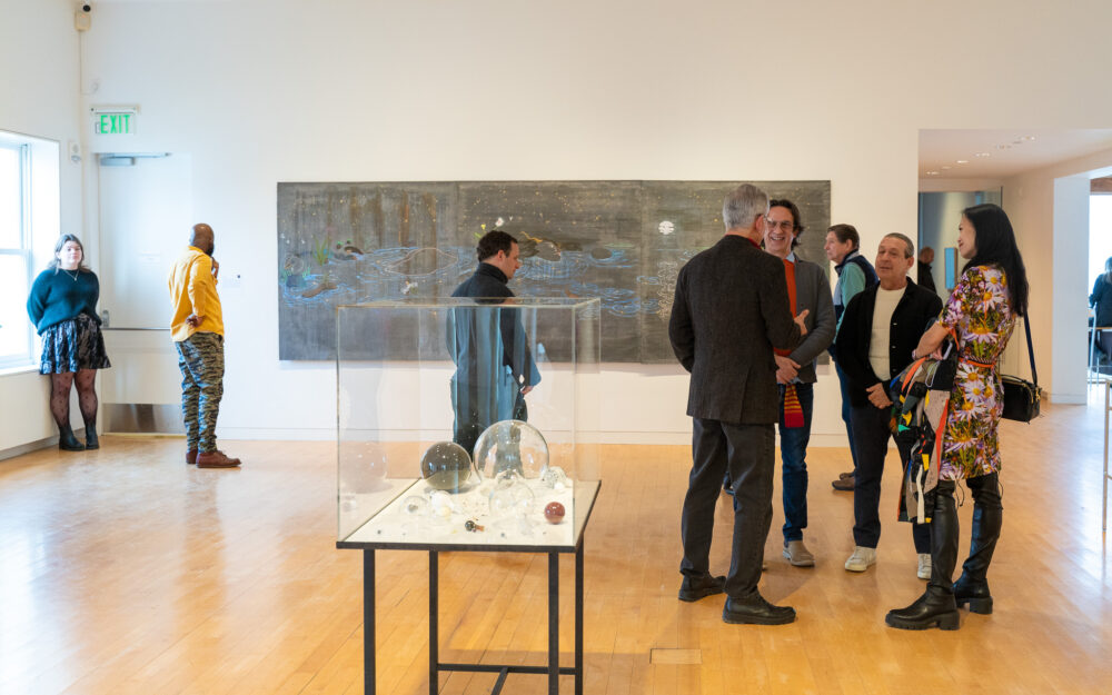 Group of people talking in an art museum gallery