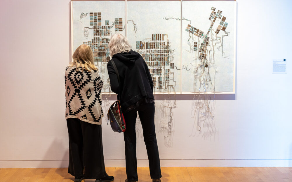 Two women looking at an artwork