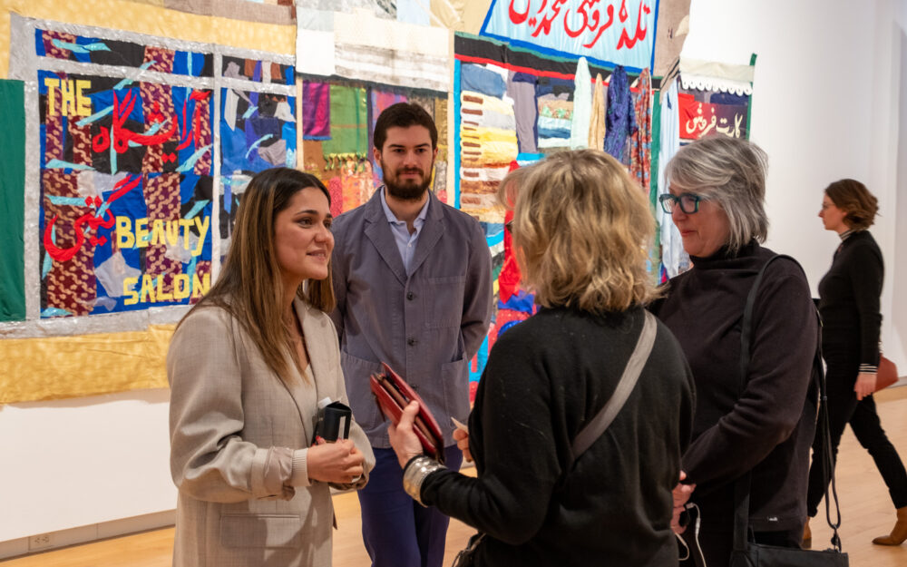 Visitors in conversation in an art gallery