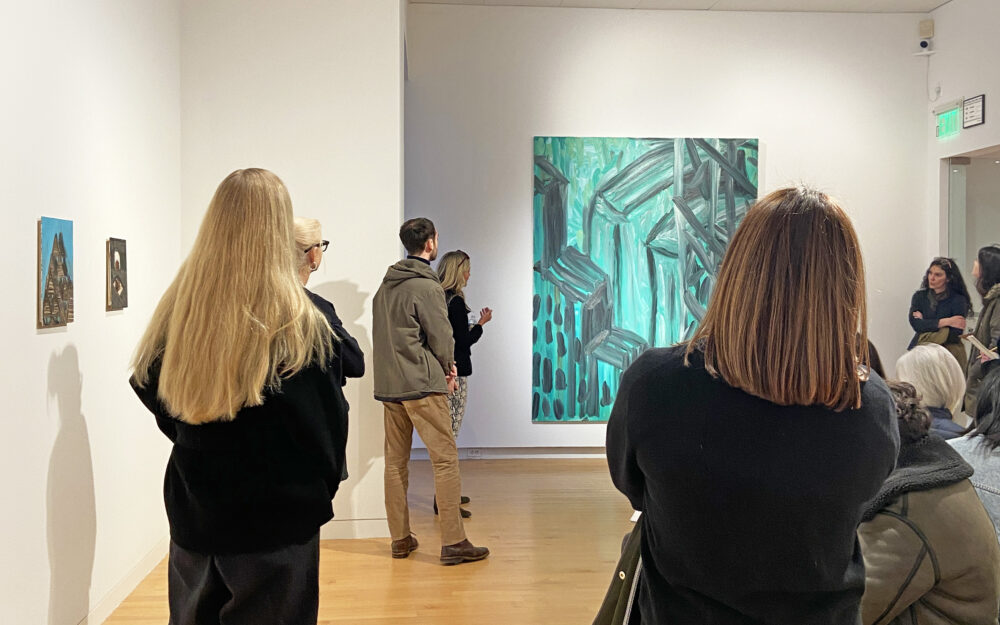 A group of people on a tour of an art museum.