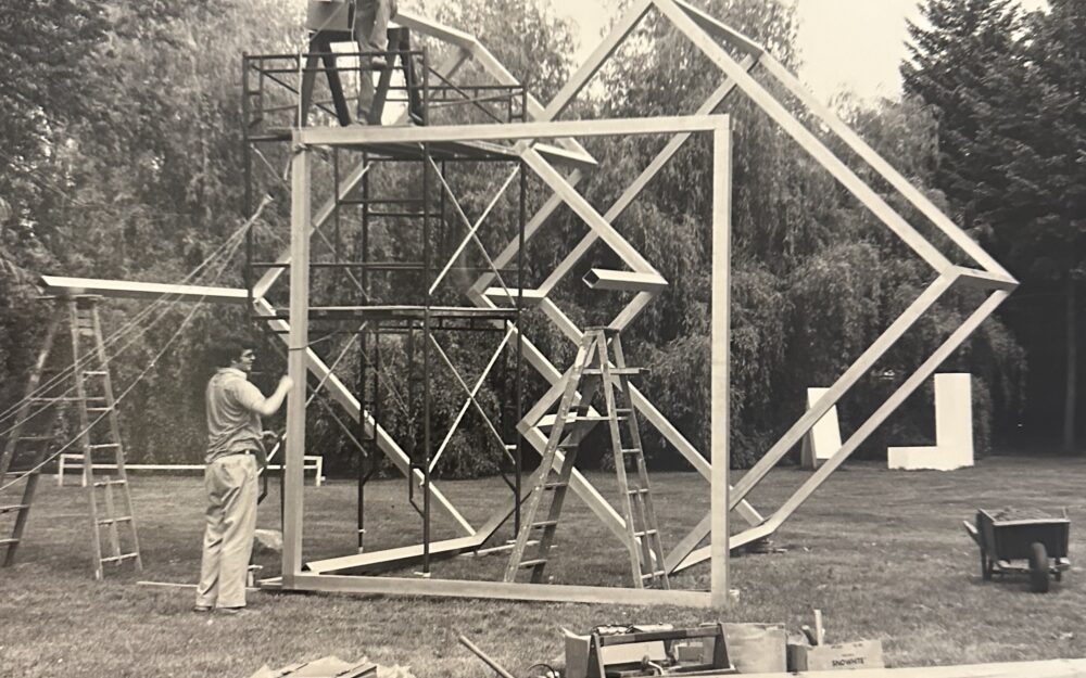 Black and white photo of geometric sculpture being installed in the Sculpture Garden