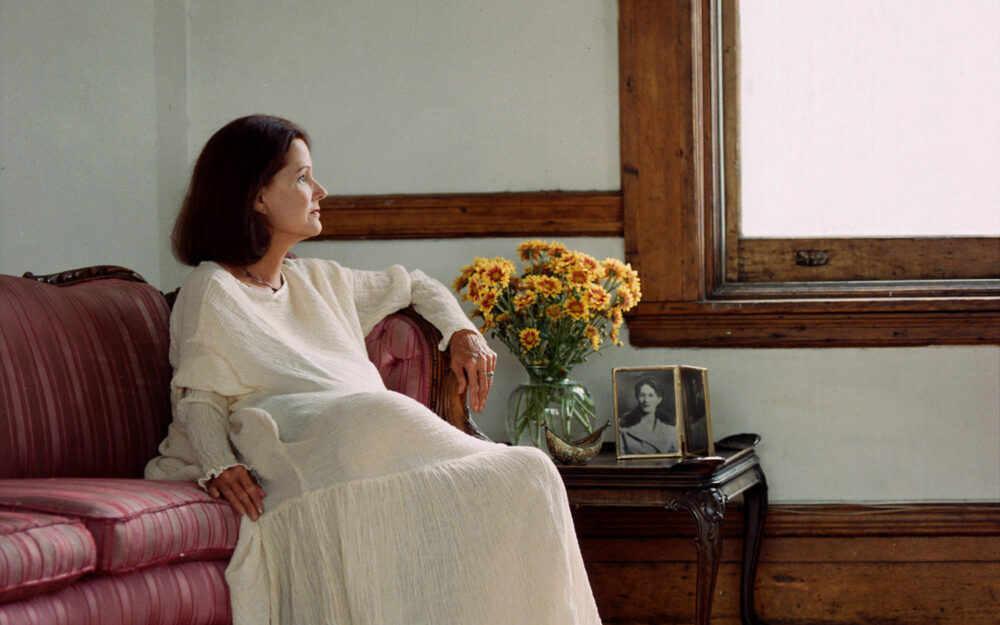 image of a woman seated by a window