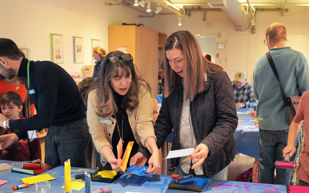 visitors engaged in a painting activity at the studio