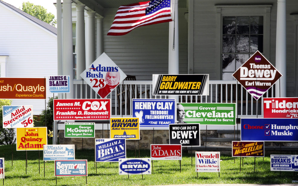 Political yard signs sit on the front lawn of the Museum's Old Hundred building
