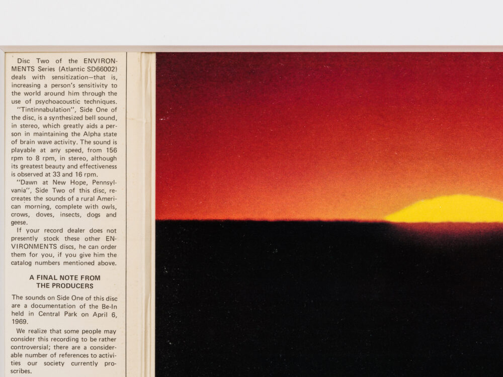 Detail of record cover with a column of text to the left and an image of a sunset to the right.