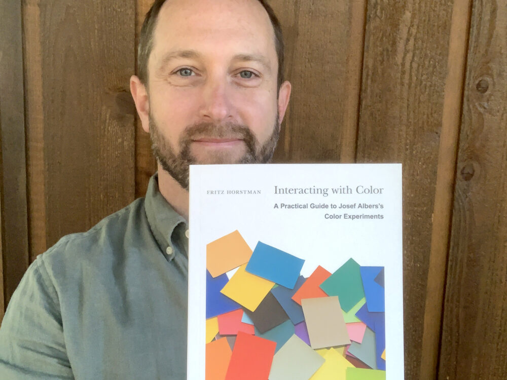 Fritz Horstman holding a copy of his book Interacting with Color