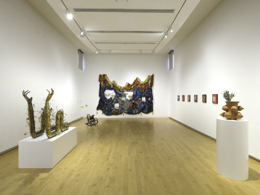 Installation view displaying multiple sculptures in an art gallery.