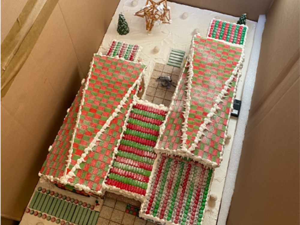 Birds eye view of a gingerbread house in a custom-made box for transportation