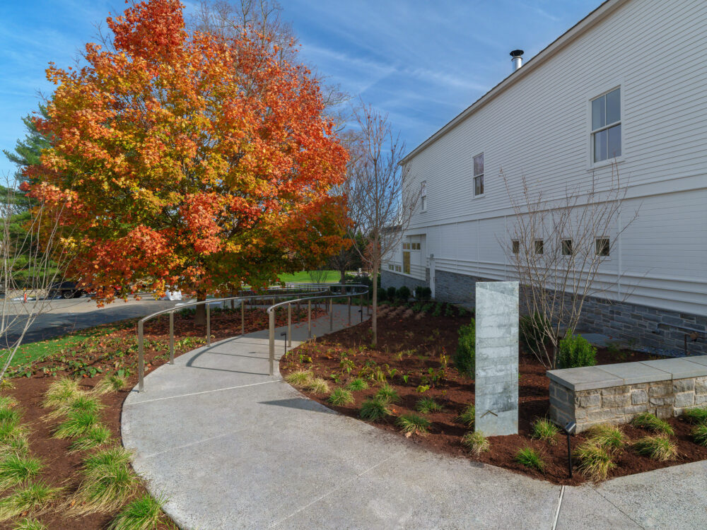 an exterior pathway adjacent to a museum building