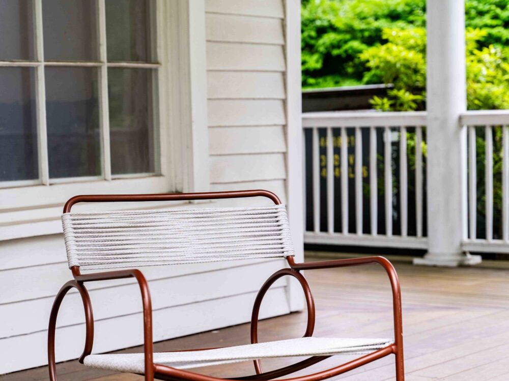 A rocking chair on a front porch