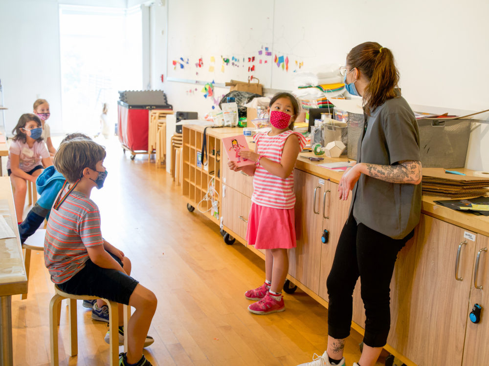 Children in an art studio with their teacher