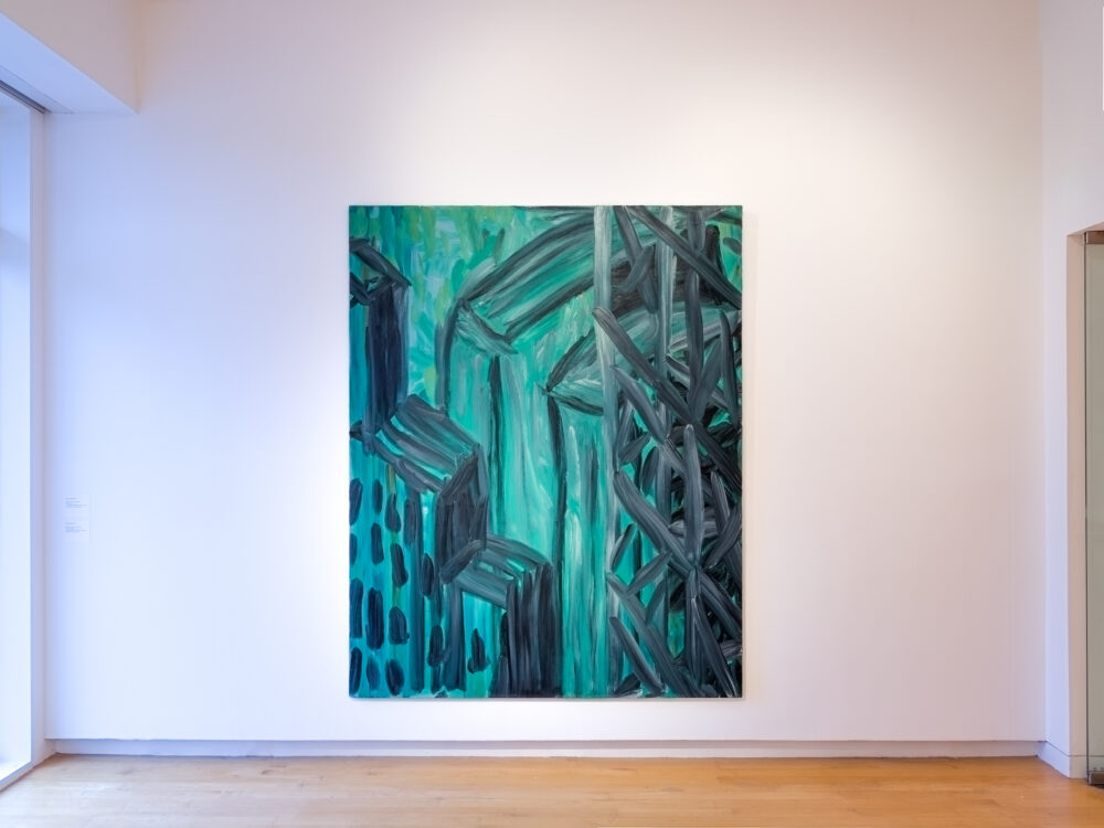 A large abstract greenish painting on a white wall.