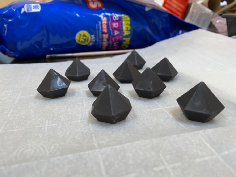Small chocolate triangles on parchment paper