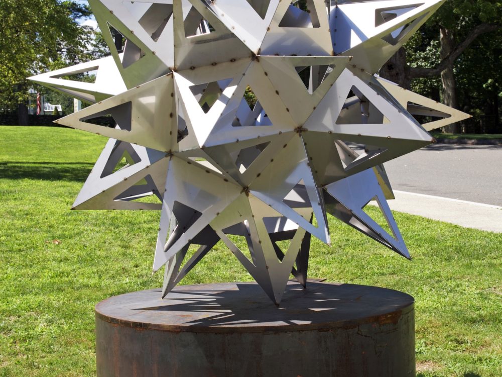 Stainless steel sculpture of an abstract star by Frank Stella sited outside on the Museum's grounds.