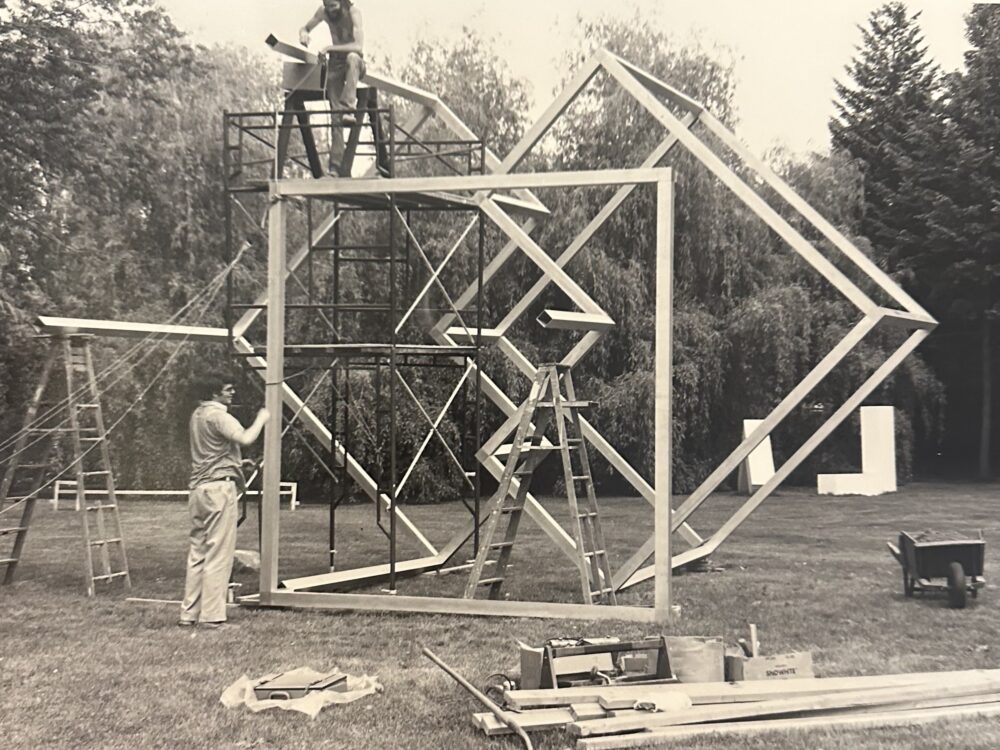 Black and white photo of geometric sculpture being installed in the Sculpture Garden