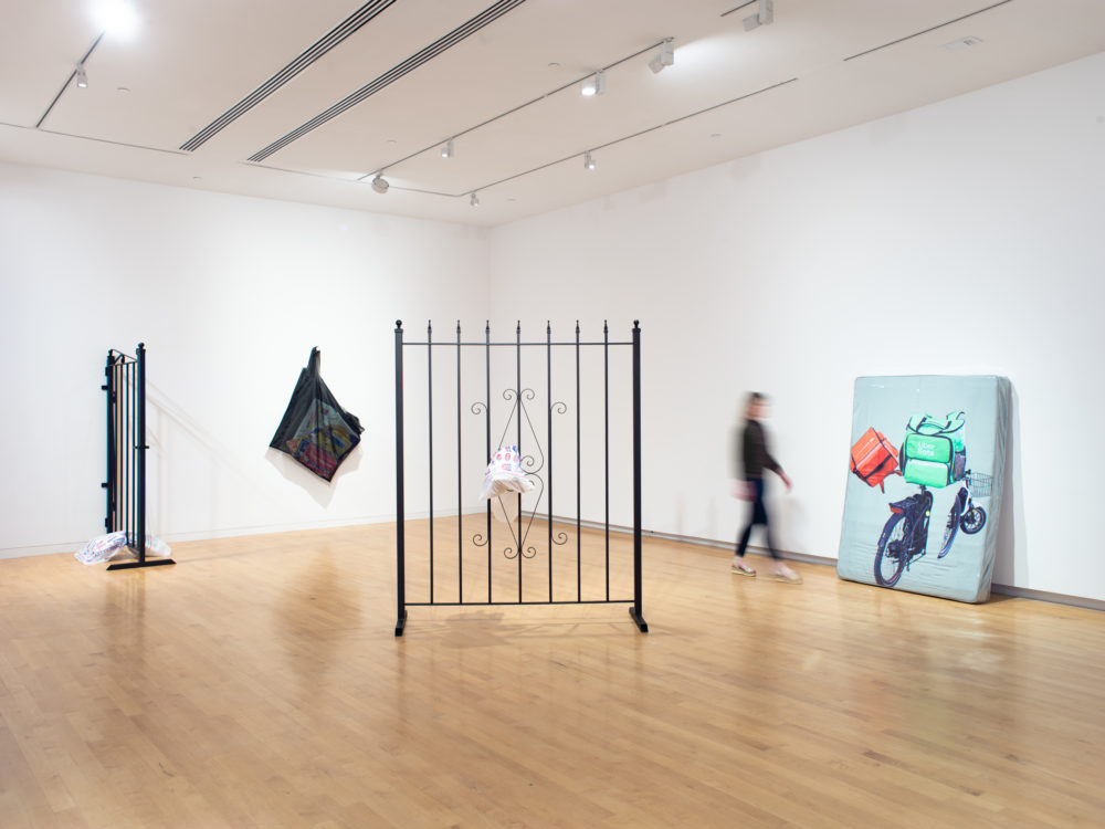 Gallery with two large metal gate sculptures