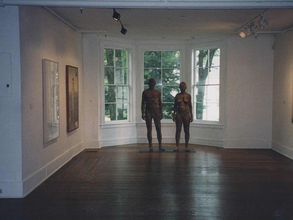 This is a photo of The Nude in Contemporary Art exhibition — each wall holds various large photographs and paintings featuring nude figures