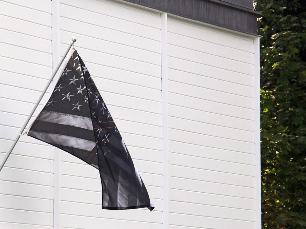 Black American flag hangs on Thee Aldrich's building