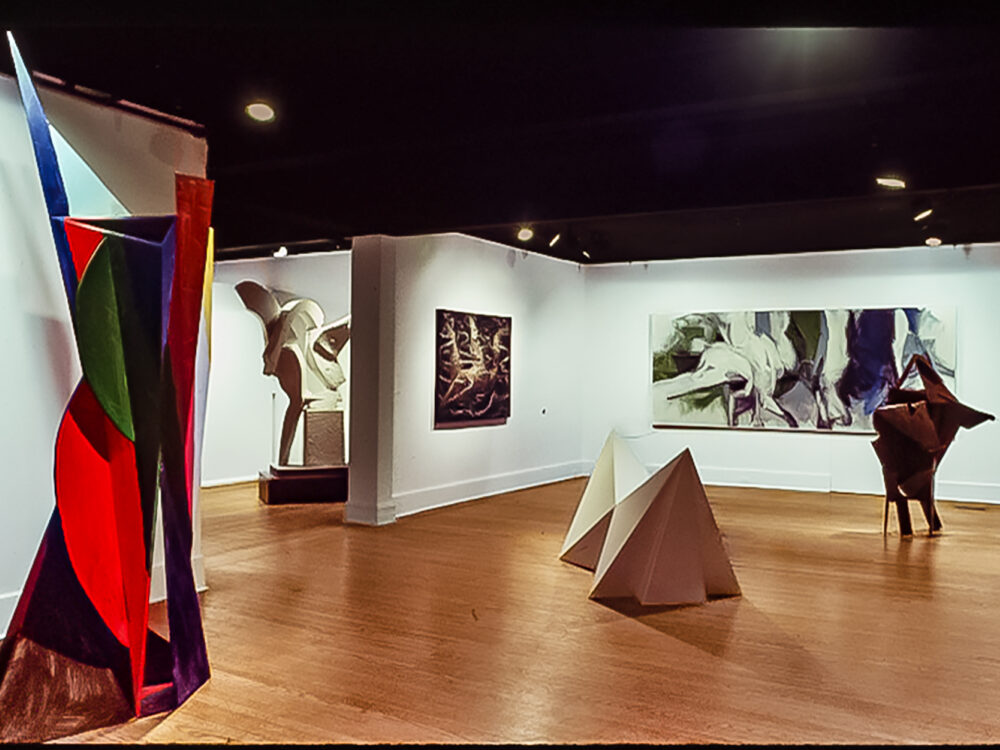 An image of an art gallery with contemporary paintings and sculptures