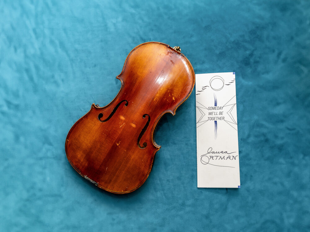 A violin with an illustrated book