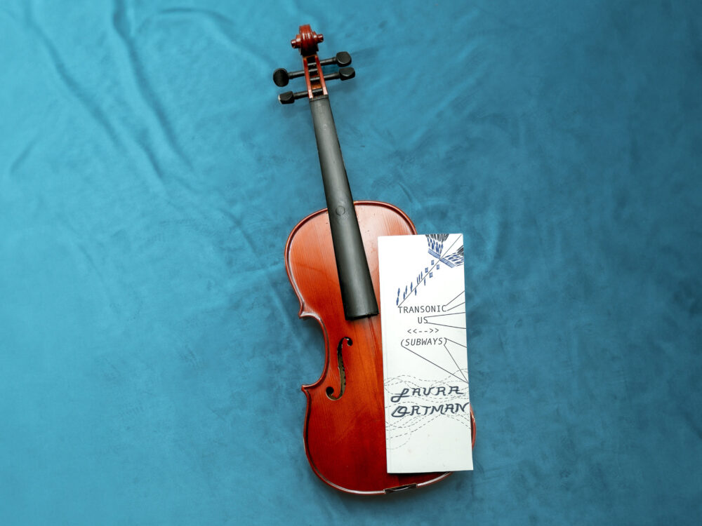 A violin with an illustrated book
