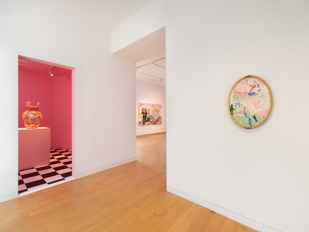 Painting hung on walls and a pink room with a ceramic sculpture inside.