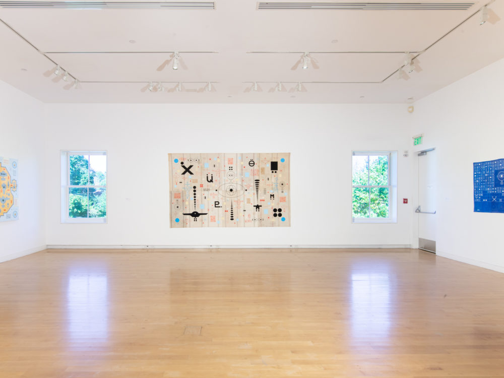 Gallery with a single painting on the center wall with a window on either side and a single painting hung on both the left and right walls.